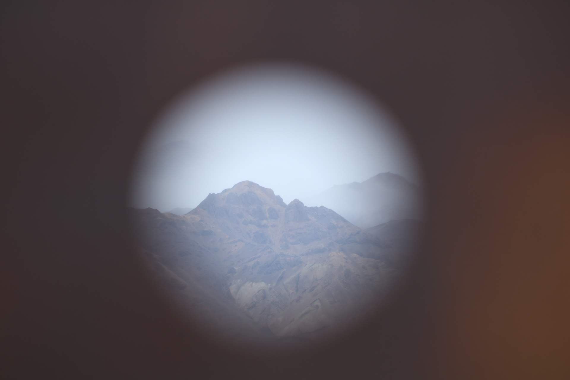 view of mountains through a peephole